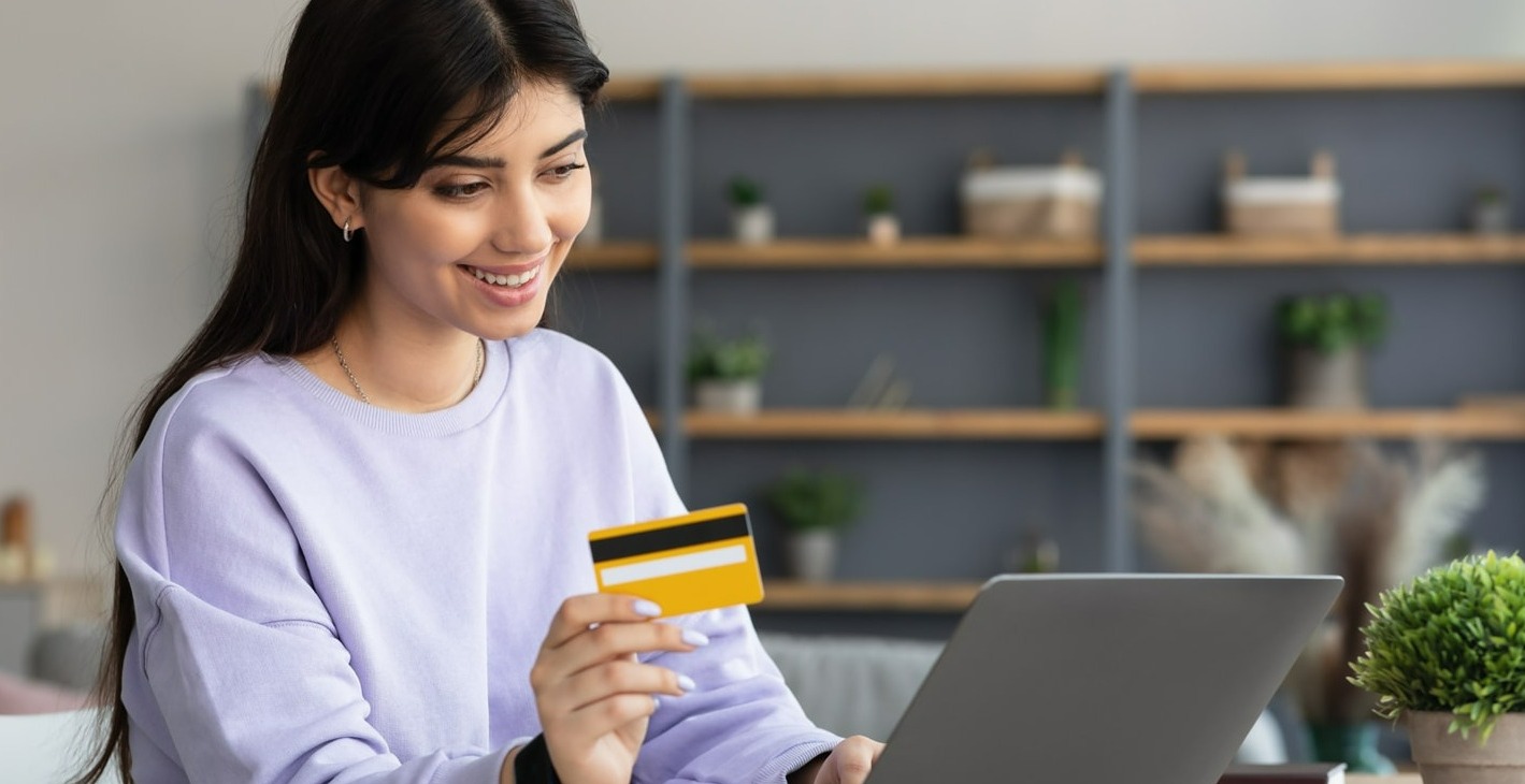 Young woman Using a credit card with laptop
