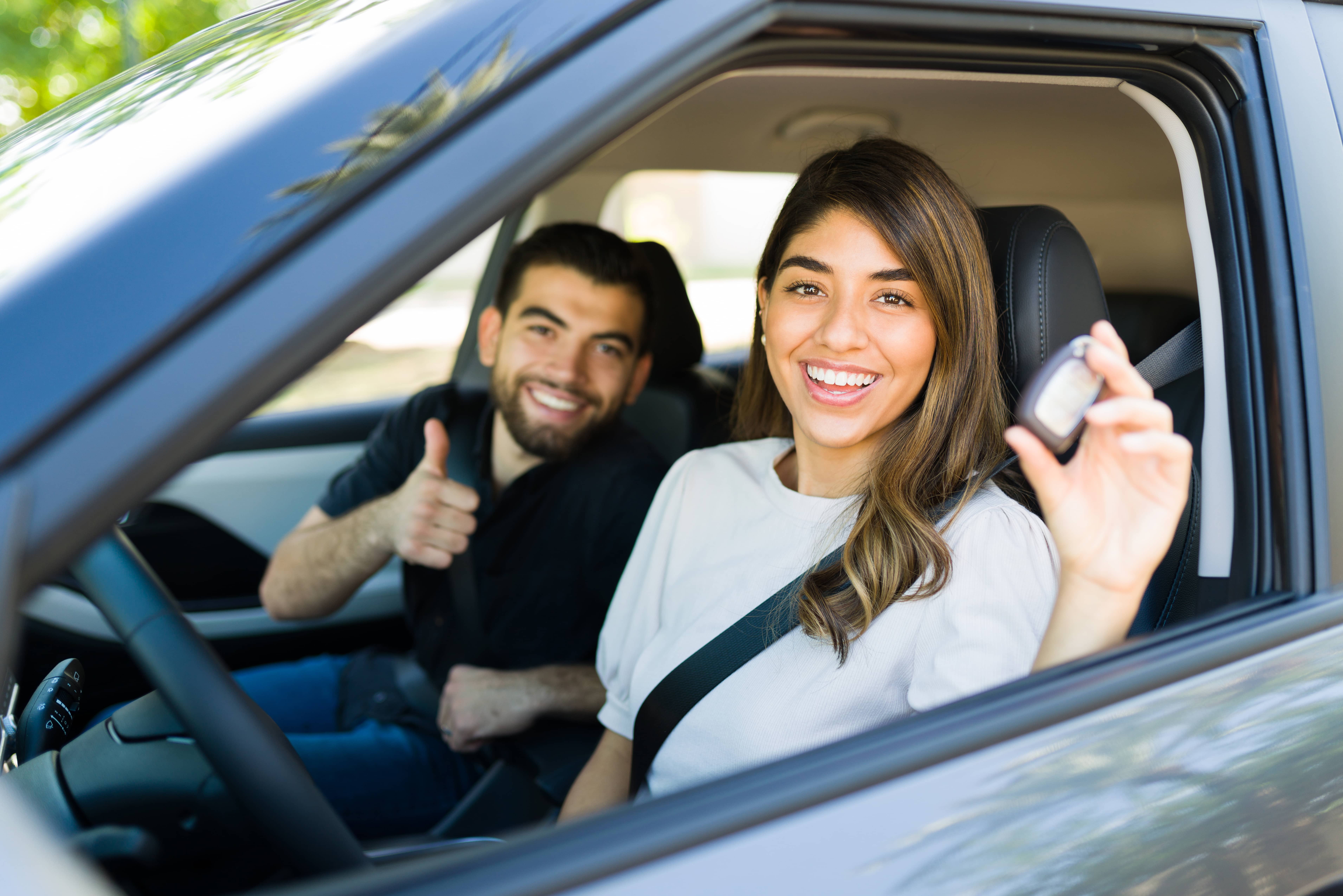 Couple showing new car