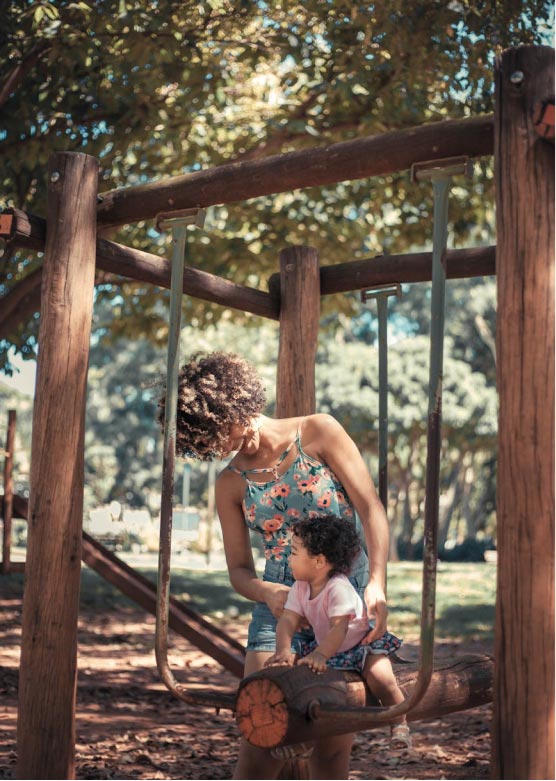 A mother and daughter playing in a park
