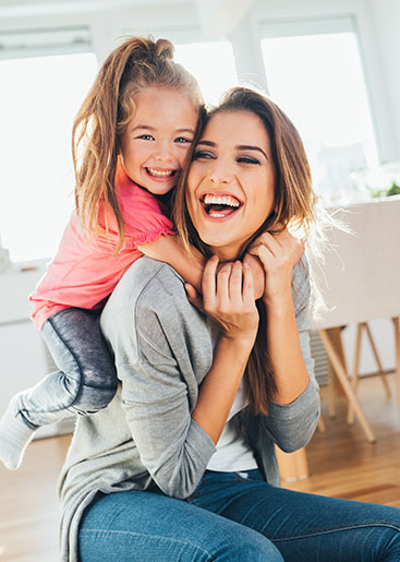 Mom playing with her daughter at home