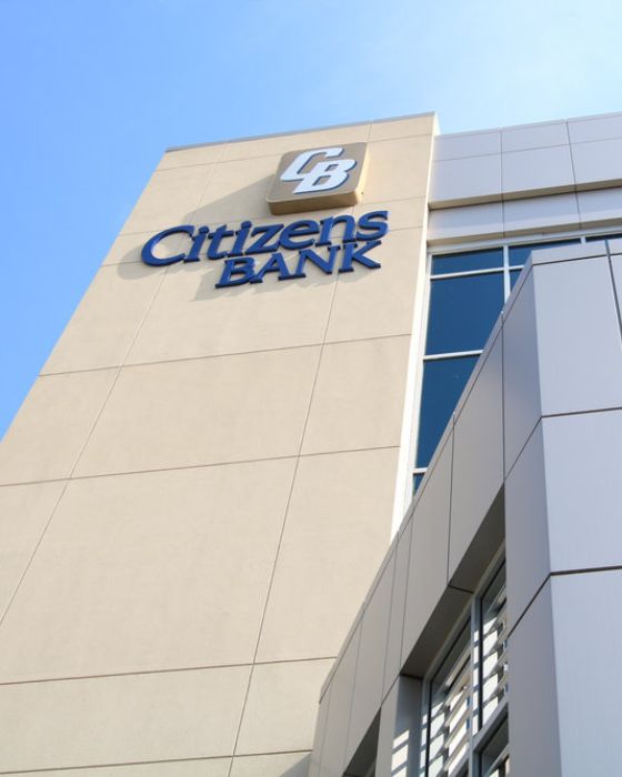 vertical view of three-story building with Citizens Bank logo at the top.