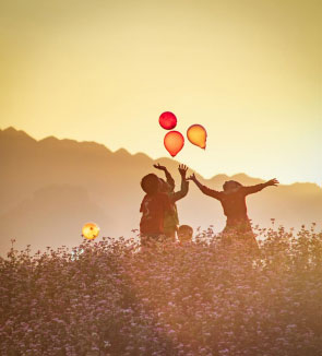 Kids playing outside with balloons