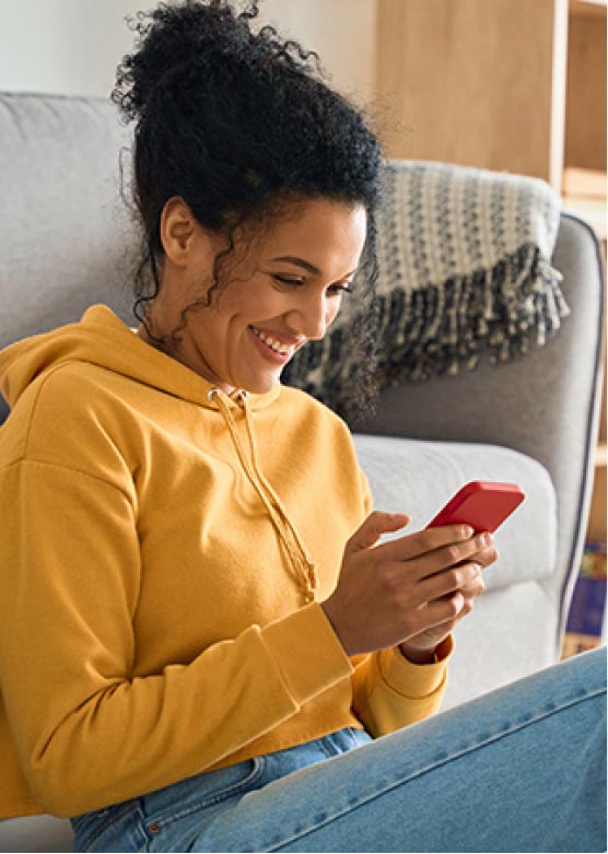 A lady using her smartphone in her living room