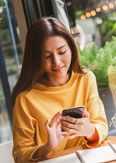 young women using phone for online banking