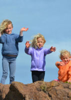 Three young kids playing outside